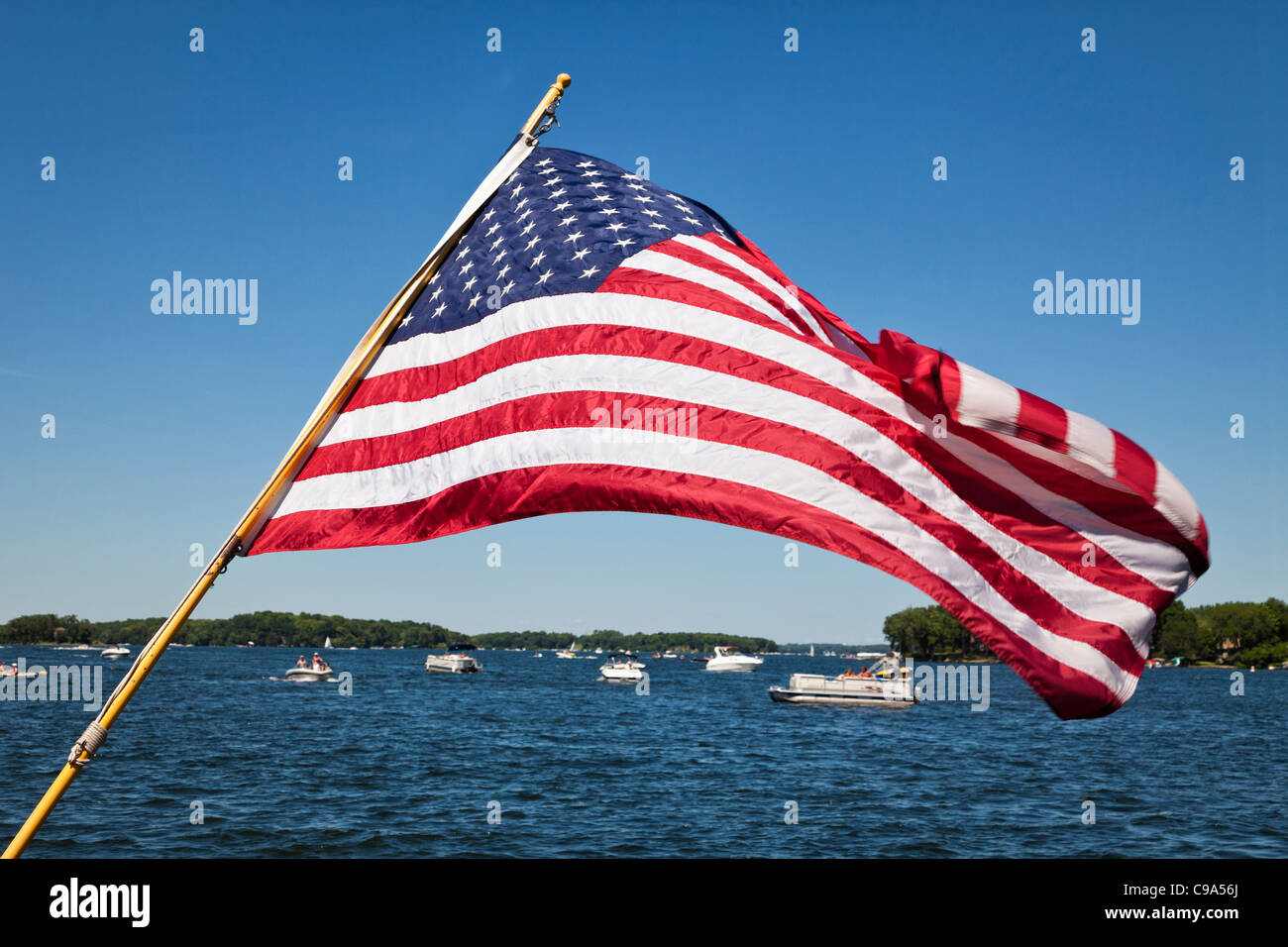 Amerikanische Flagge über Lake Minnetonka Sportboote am 4. Juli InExcelsior, Minnesota. Stockfoto