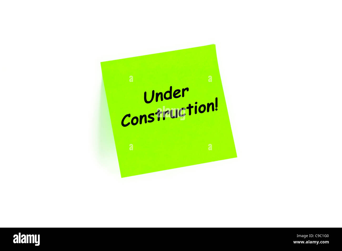 Im Bau auf einer Note, Isolated On White Stockfoto