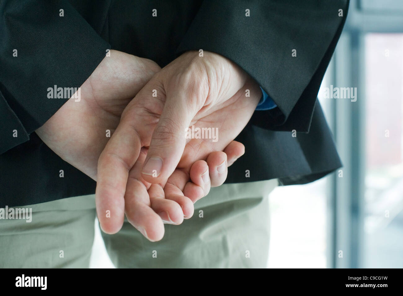 Gefalteten Händen hinter dem Rücken, hintere Ansicht, beschnitten Stockfoto