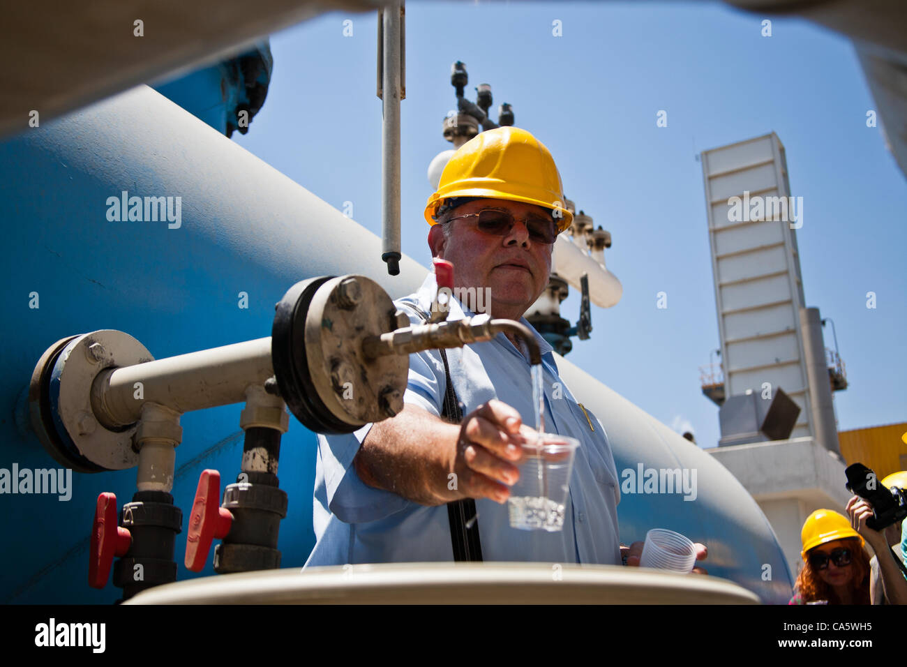 Abraham Tene, Vorsitzender des Wasser Entsalzung Verwaltung und Entsalzung Bereichsleiter bei der Wasserbehörde Israel trinkt entsalztes Meerwasser in Ashkelon Entsalzungsanlage produziert. Ashkelon, Israel. 13. Juni 2012. Stockfoto