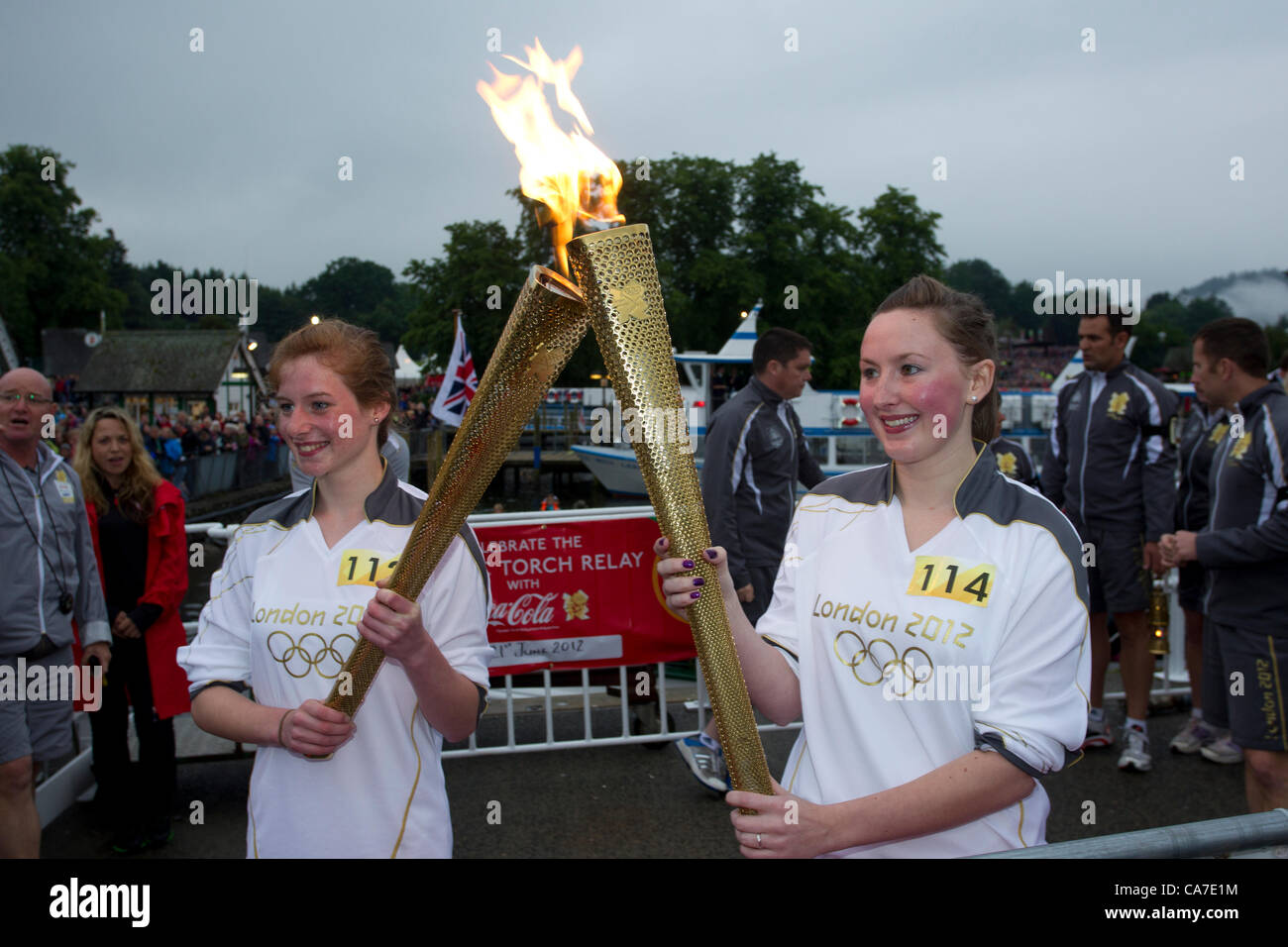 Stephanie Booth und Jan Booth mit Olympische Fackel Dampf Cruiser The Tern bei der Ankunft in Bowness auf Windermere er Olympische Feuer an der historischen Dampfschiff Tern an Waterhead Pier Bord bereisen zu Bowness auf Windermere.In eines der größten Spektakel, die jemals in den Lake District, die Flamme der See von hundert andere Schiffe eskortiert überquert. Die Hauptaufgabe der Fackel-Sicherheitsteam Läufer - hier in grau - gesehen ist die Kontinuität der Flamme zu schützen und so zum Schutz der Fackel und Fackelträger TST Olympischer Fackellauf Stockfoto