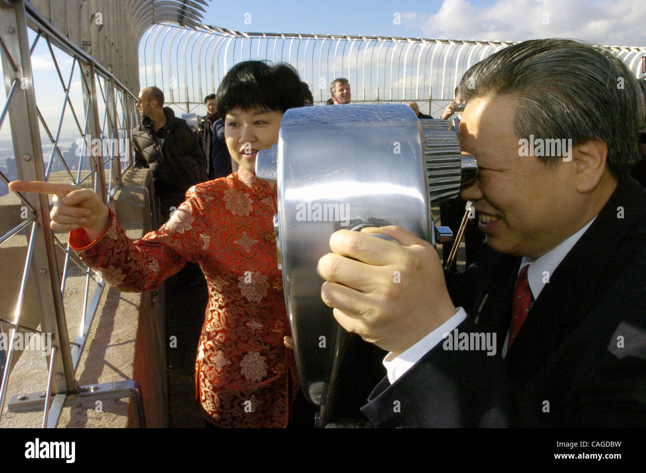 Consul General Ambassador Peng Keyu (R) und seine Frau Jingmei Yang (L) auf der 86. Etage Aussichtsplattform. Generalkonsul Botschafter Peng Keyu leitet im Auftrag des Generalkonsulats der Volksrepublik China in New York eine Zeremonie auf dem Empire State Building, ziehen einen gi Stockfoto