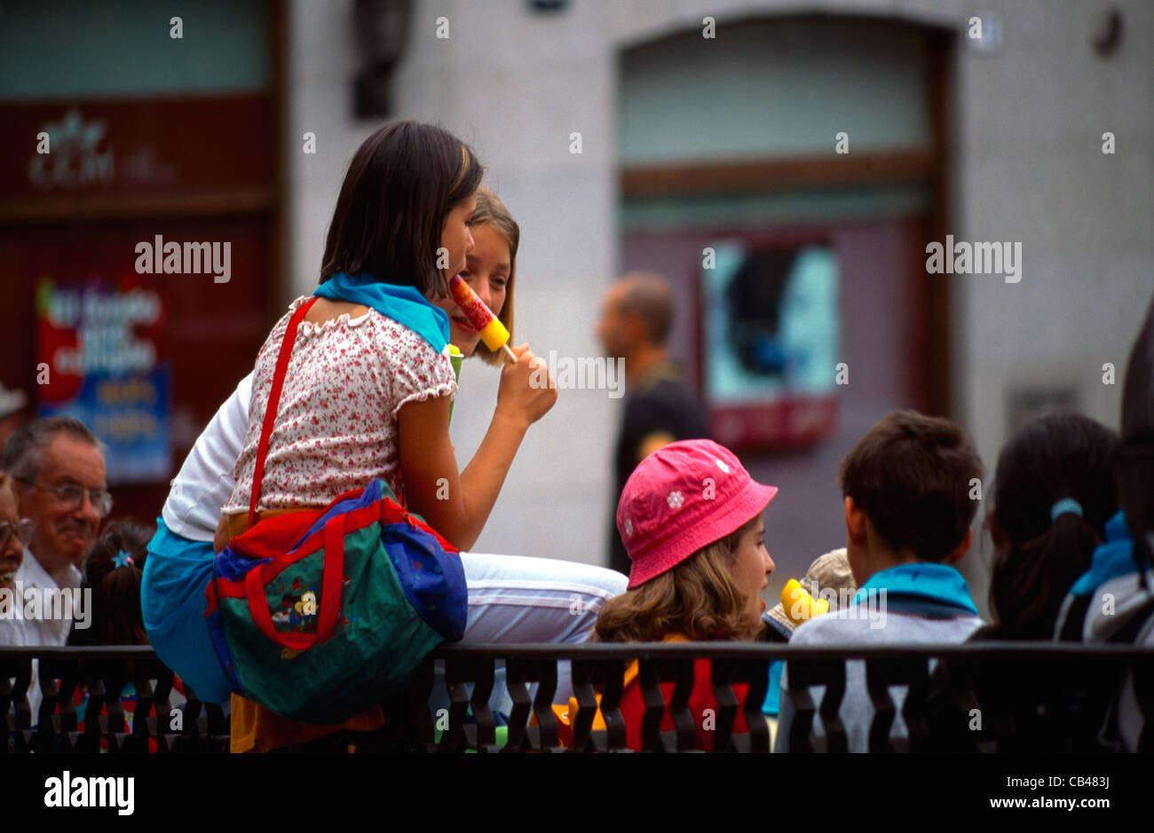 Madrid Spanien Retiro Park School Mädchen essen Eis am Stiehl sitzen auf Geländer Stockfoto