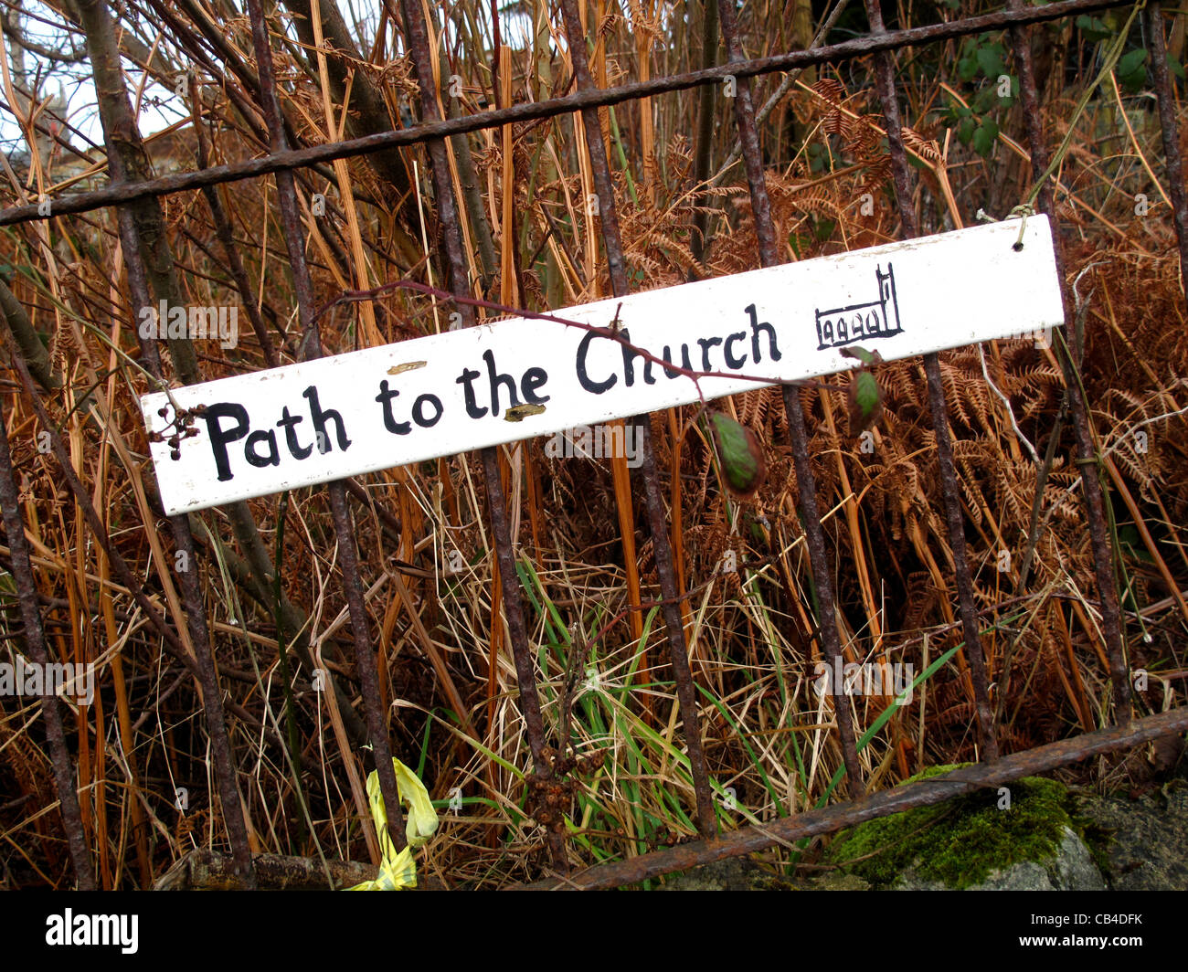 Rustikale Zeichen für den Weg zur Kirche am Zaun Stockfoto