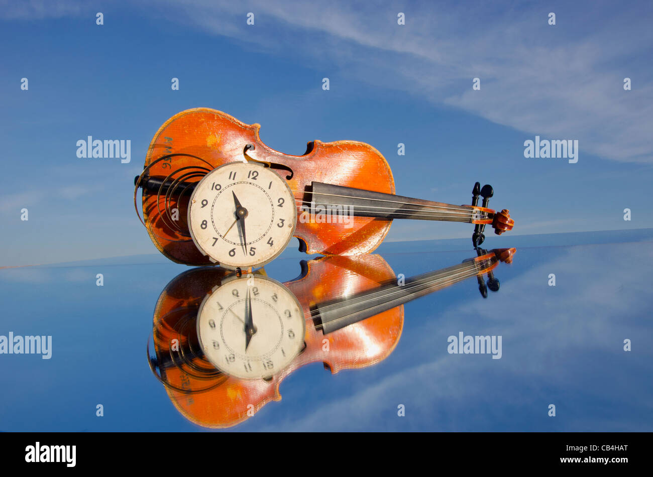 Alte Geige und Ziffernblatt auf Spiegel Stockfoto