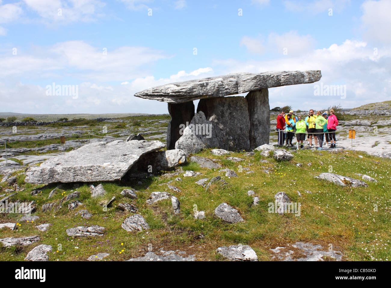 Tourguide zeigt Touristen die Poulnabrone Dolmen in die Burren, County Clare, Irland Stockfoto