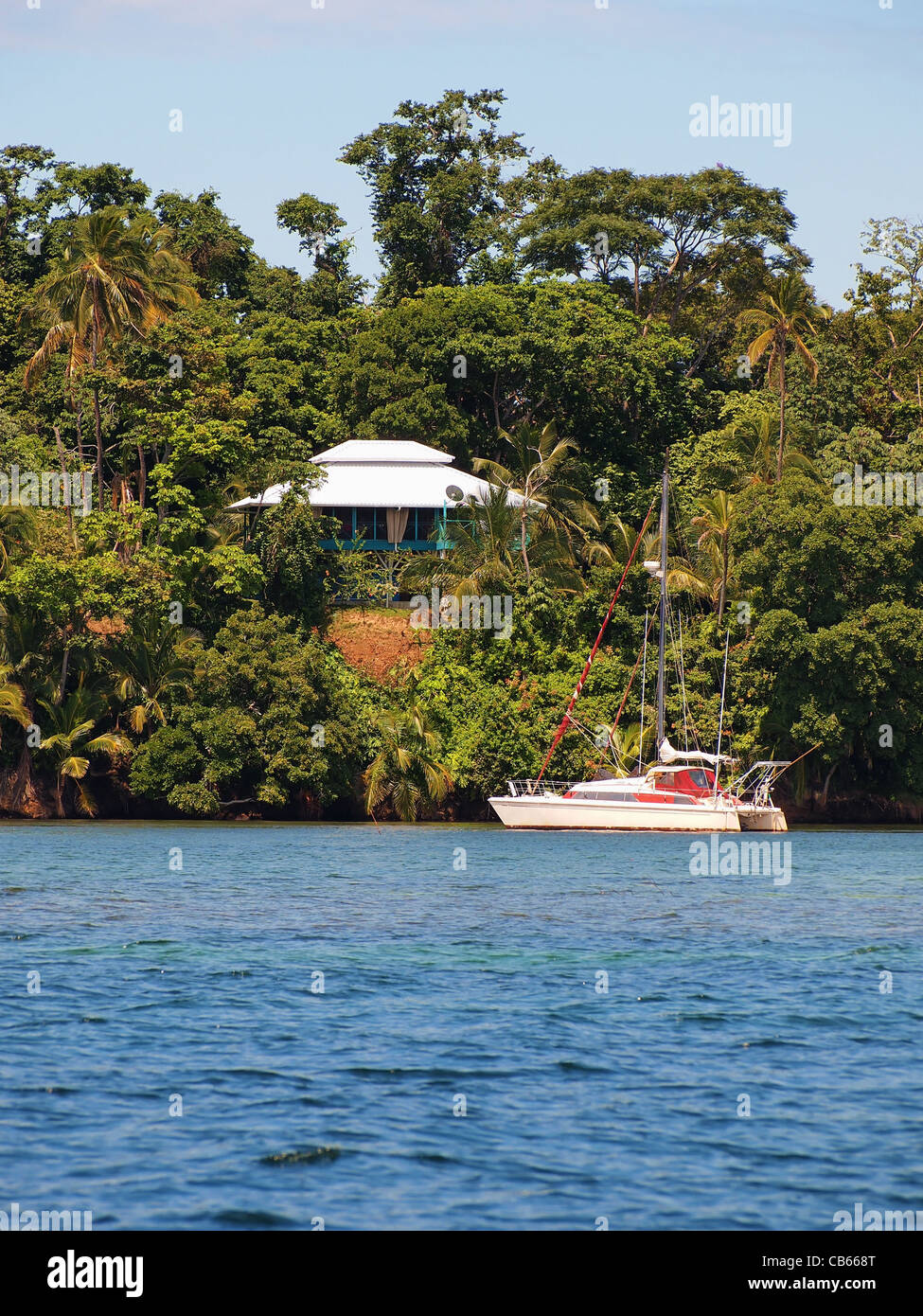 Karibisches Haus mit einem Segelboot auf dem Archipel von Bocas del Toro, Panama Stockfoto