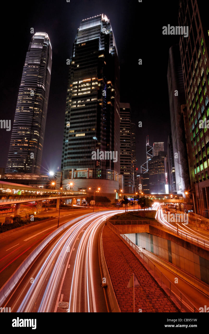 Nacht im International Finance Center in Hong Kong mit roten Lightstreaks aus dem Verkehr. Stockfoto