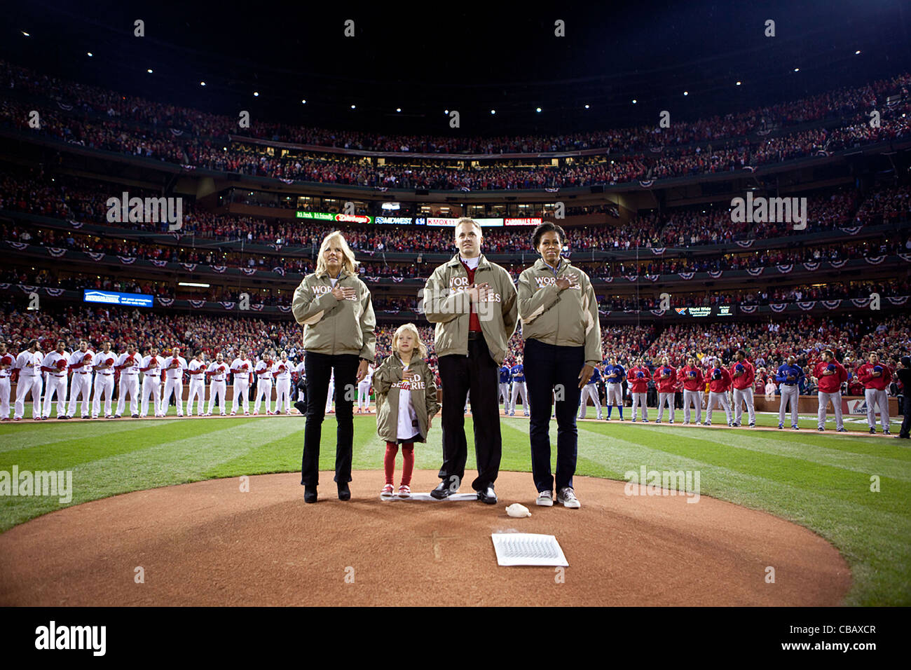 First Lady Michelle Obama und Dr. Jill Biden, mit Veteran James Sperry und seine Tochter, Hannah, pause für die Nationalhymne vor dem Spiel 1 der Baseball World Series im Busch Stadium 19. Oktober 2011 in St. Louis, Missouri. Stockfoto