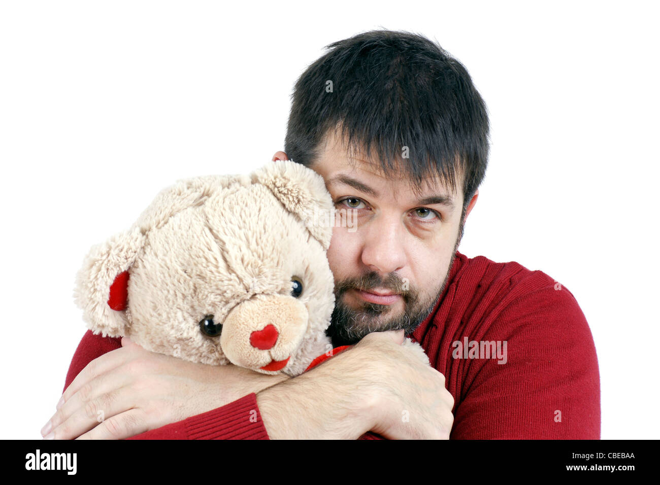 Widerspruch: großen harten mittleren Alter bärtiger Mann geben eine große Umarmung, ein Teddybär weich und süß. Stockfoto