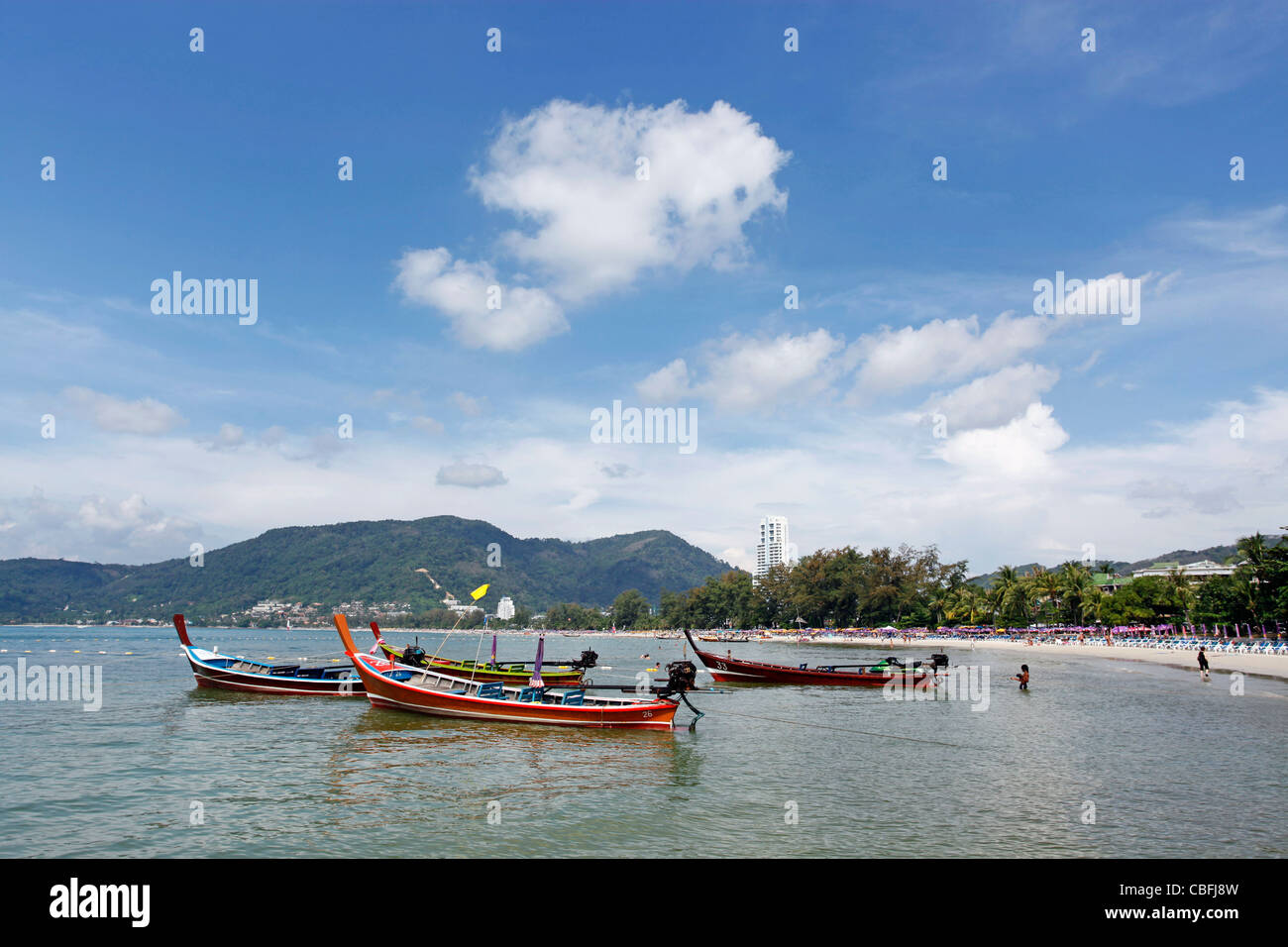 Traditionelle Thai lange tailed Boote in die Bucht von Patong Beach in Patong, Phuket, Thailand Stockfoto