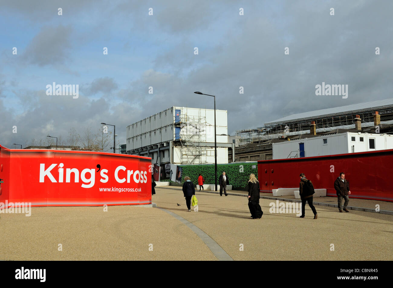 Kings Cross aufgedruckten roten Werbetafeln, Kings Cross zentrale Entwicklung vor Ort, Ecke des Königs Boulevard mit Passanten Stockfoto