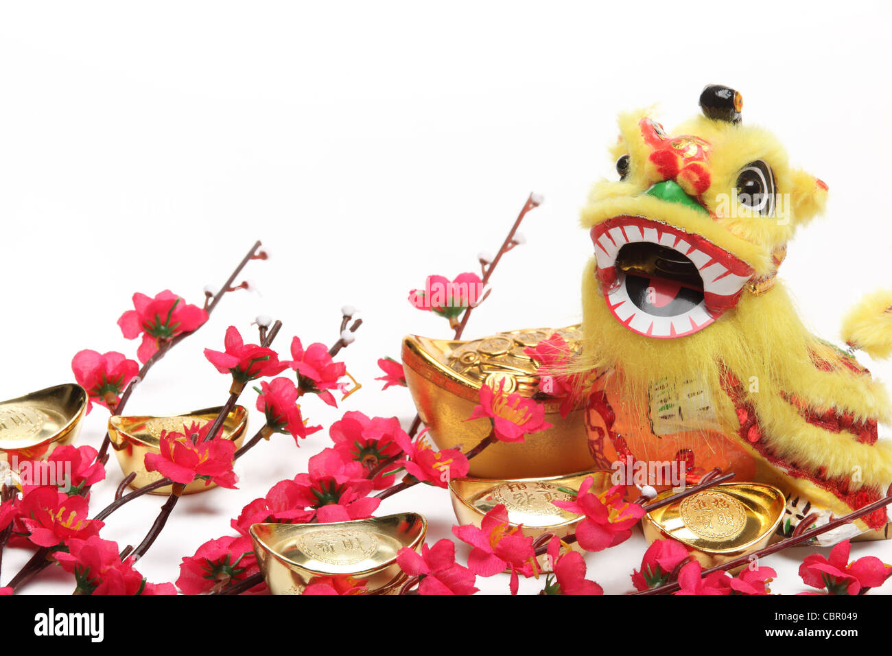 Chinese New Year Dekorationen--traditionelle tanzende Löwen, Goldbarren und Pflaumenblüte. Stockfoto
