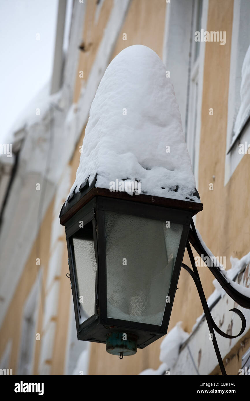 Straße Laterne mit großen Schneewehe Hauswand hängen Stockfoto