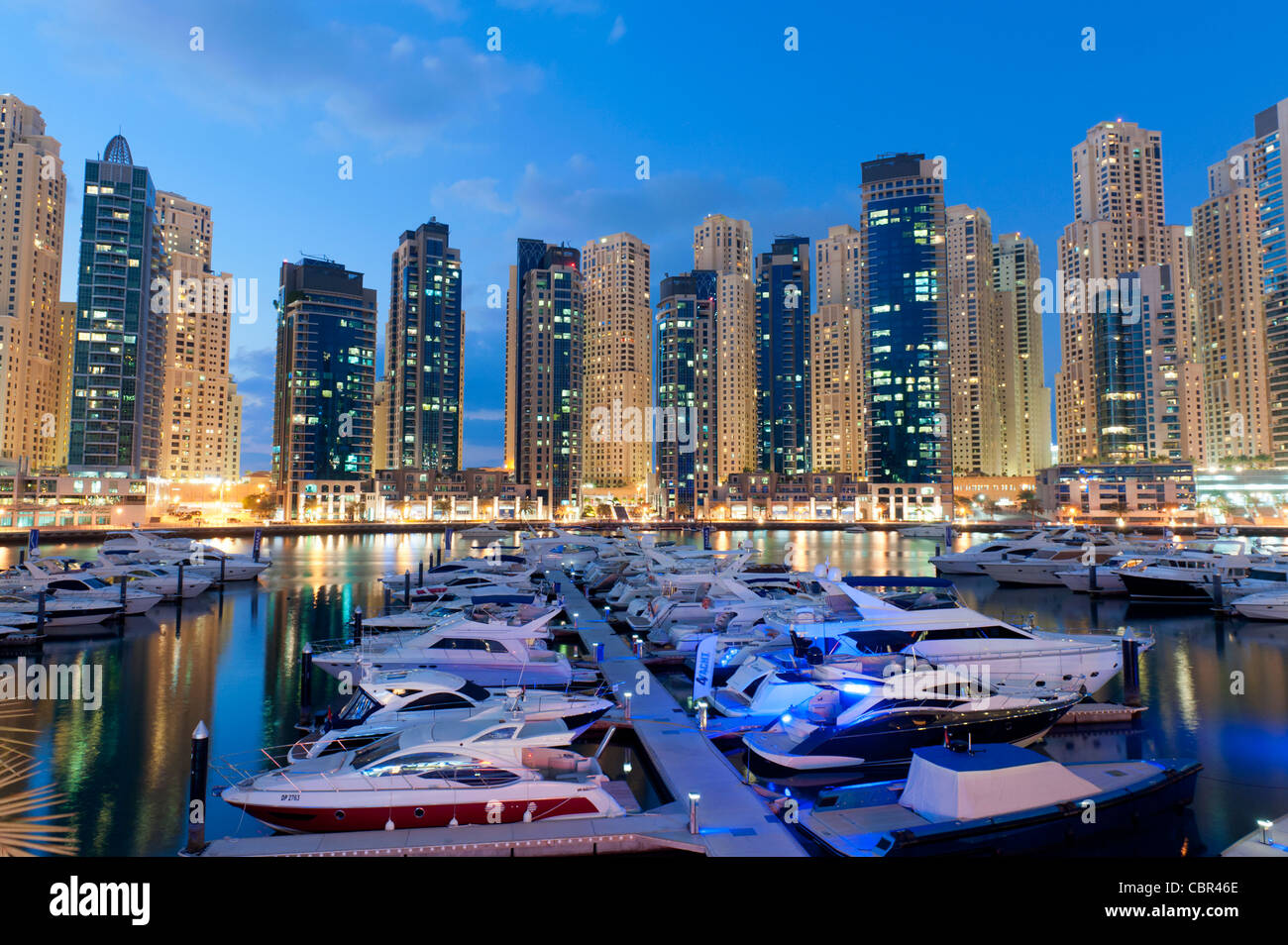 Boote im Hafen am Abend im Yachtclub Marina mit Apartment-Türme in New Dubai in Vereinigte Arabische Emirate nach hinten Stockfoto