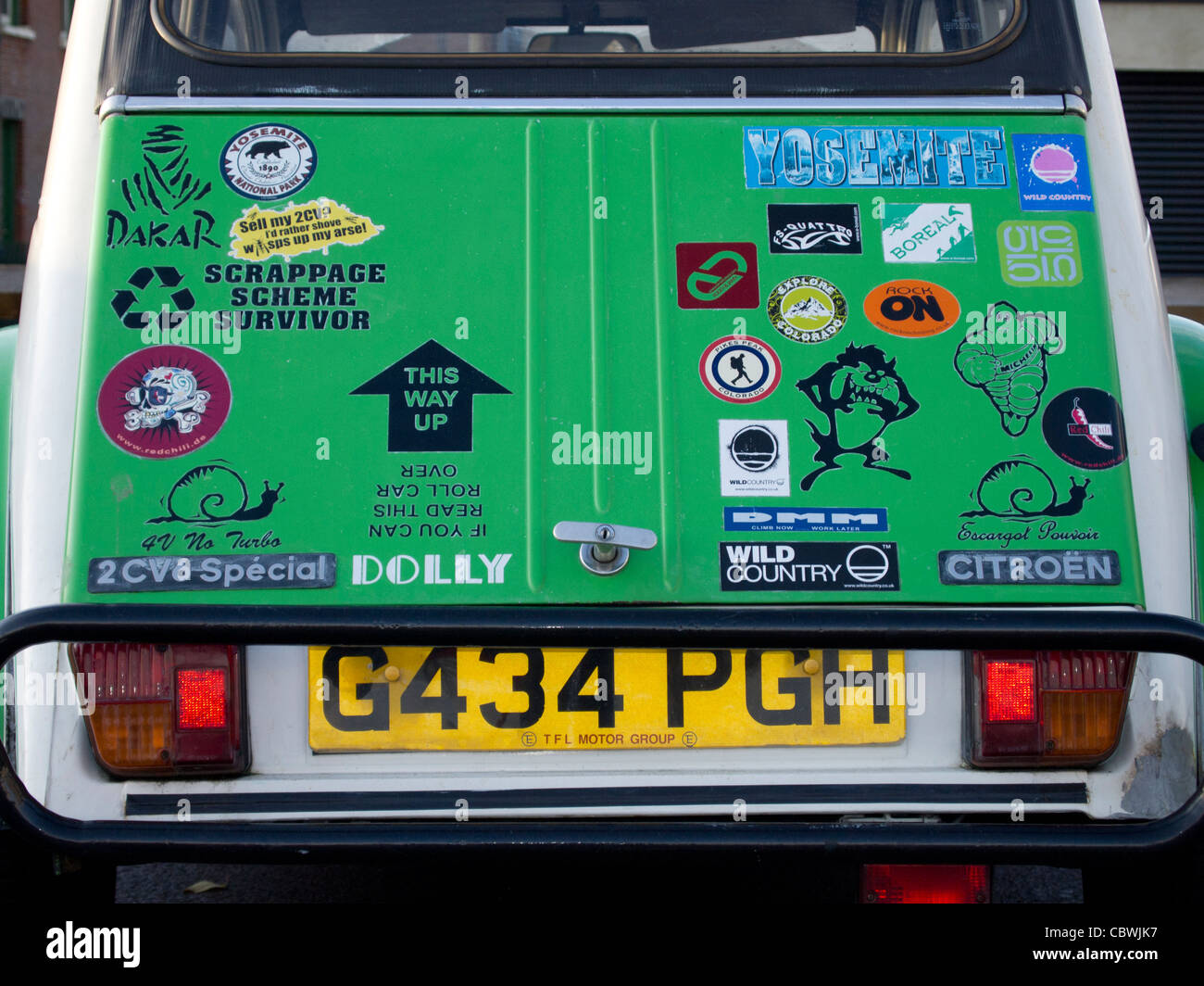 Eine Vielzahl von Aufklebern verzieren den Kofferraum eines Autos Citroen 2CV. Stockfoto