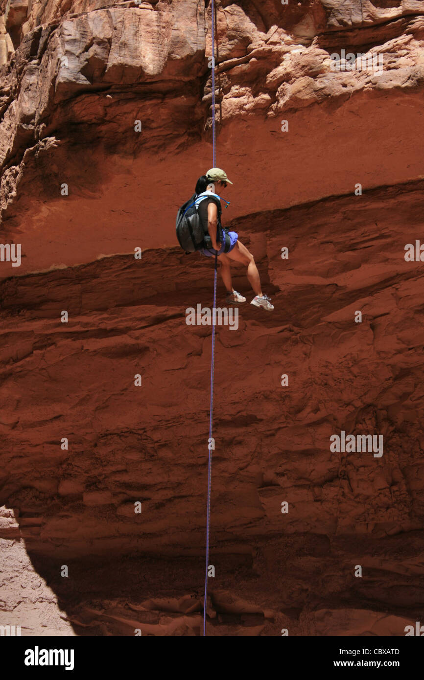 Canyoning Asiatin Abseilstellen in einer schattigen Schlucht im Grand Canyon National Park Stockfoto