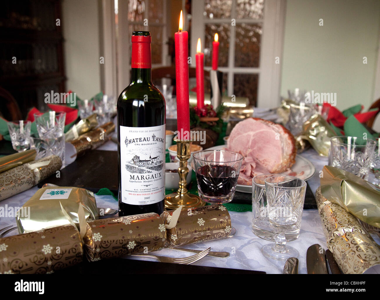Claret, Kerzen und Knallbonbons auf einem traditionellen britischen Weihnachtsabendtisch, Großbritannien Stockfoto