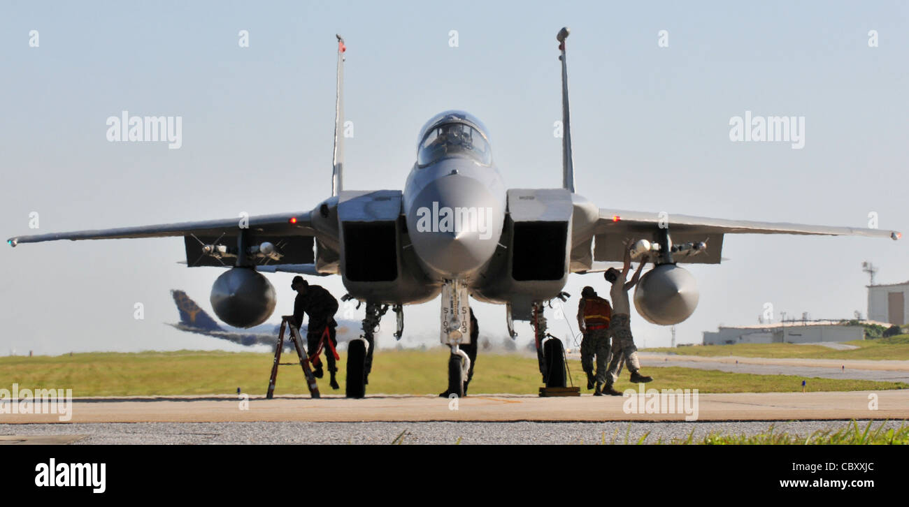 Eine kleine Gruppe von Flugern der 67. Flugzeugwartungseinheit sorgt dafür, dass die F-15C-Adler vor dem Start am 23. Februar 2010 auf der Kadena Air Base, Japan, eine letzte Kontrolle am Ende der Start- und Landebahn erhalten. Kadena Airmen nahmen vom 22. Bis 26. Februar an gemeinsamen bilateralen Trainings mit anderen US-Streitkräften und der Japan Air Self Defense Force Teil. Stockfoto