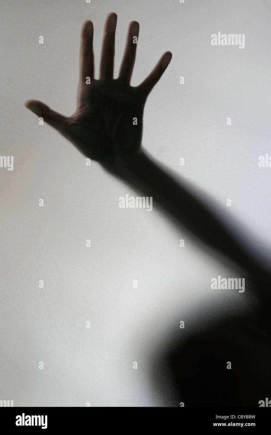 Einer Hand gegen eine diffuse Bildschirm gedrückt Stockfoto