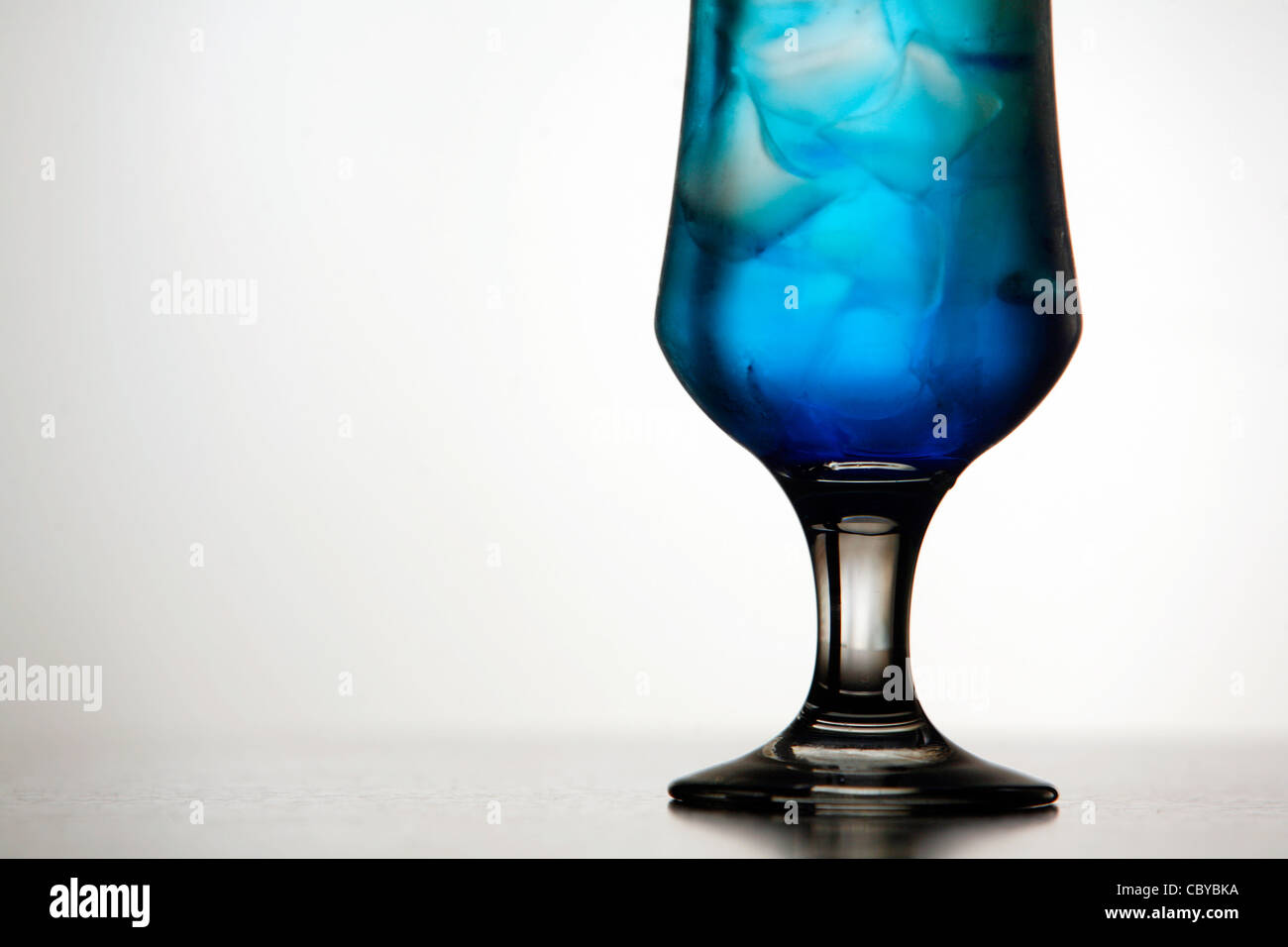 Detail eines blauen cocktail mit Eis auf weißem Hintergrund Stockfoto