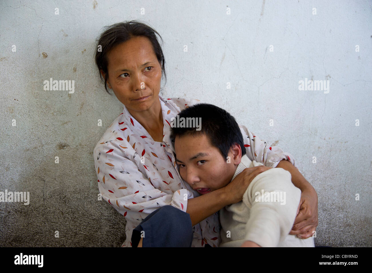 Porträt einer Mutter mit ihrem Jugendlichen behinderten Sohn, Vietnam. Stockfoto