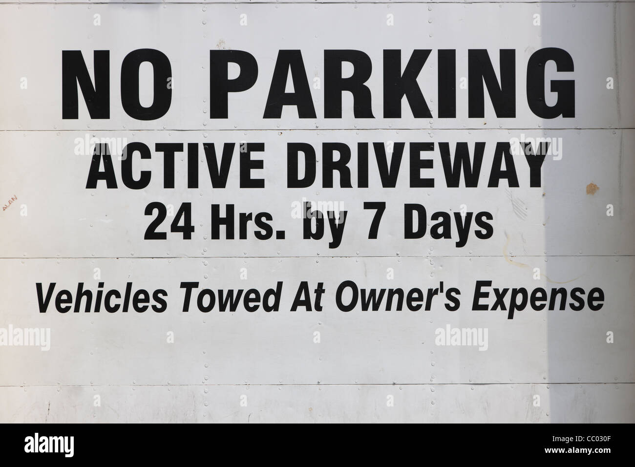 Ein "No Parking" Zeichen auf eine aktive Einfahrt Garagentor in New York City. Stockfoto