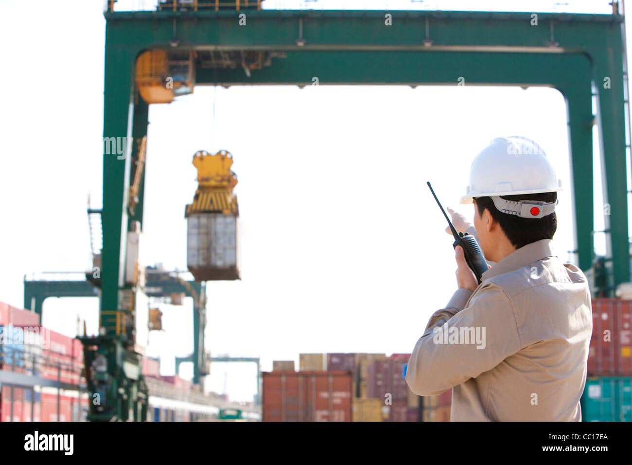 Versand Industrie Arbeiter Regie Krane mit seinem walkie-talkie Stockfoto