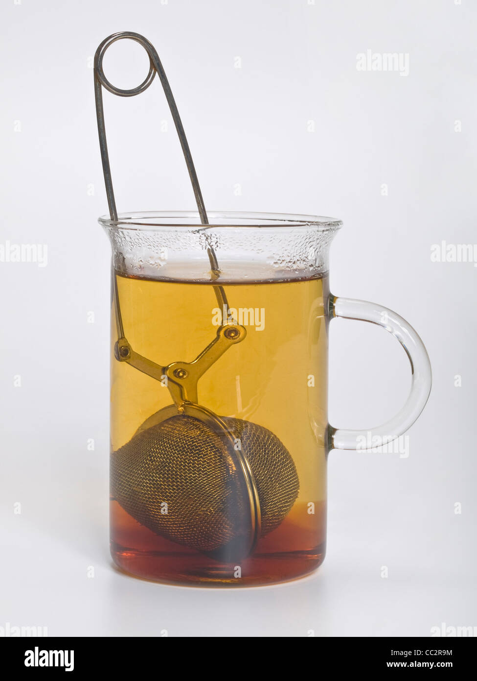 ein Glas mit schwarzem Tee gebraut, das Teesieb ist im Glas Stockfoto