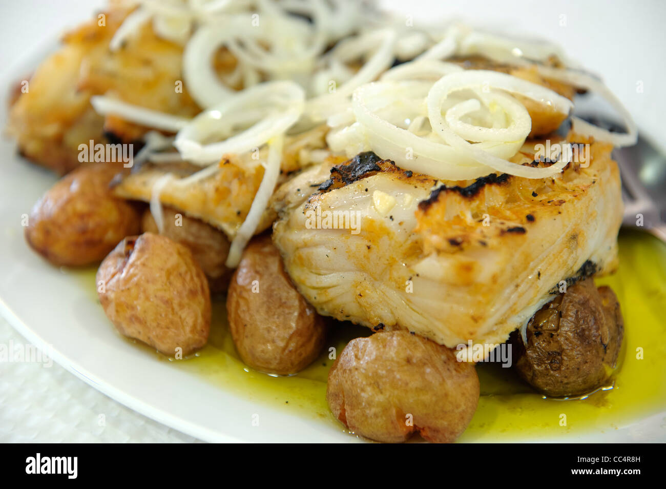 Typische portugiesische Gericht Bacalhau ein Lagareiro (Kabeljau mit Olivenöl, Zwiebeln und Kartoffeln) Stockfoto