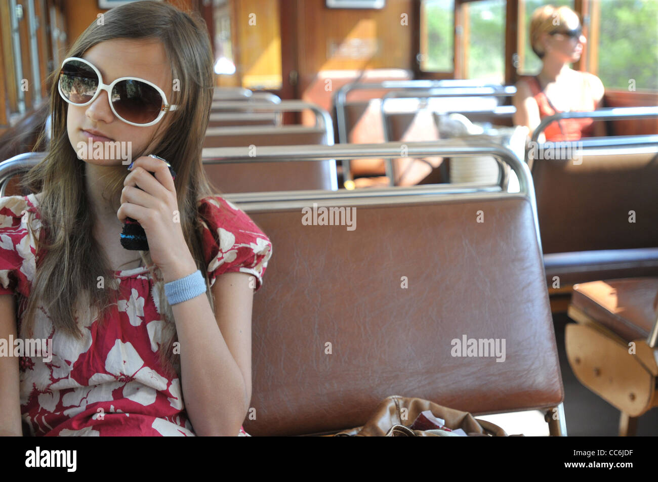 Ein 13 Jahre altes Mädchen sitzt neben ihrer Mutter in einem Zug auf Mallorca Stockfoto