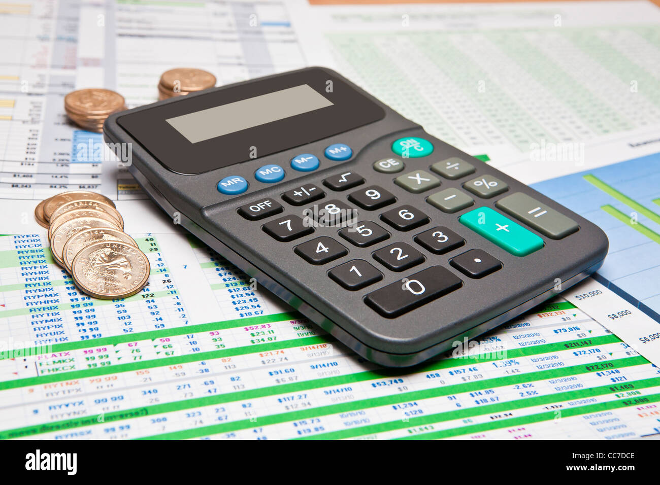 Rechner und Dollar Münzen uns auf verschiedenen Geschäftsdokumenten Stockfoto