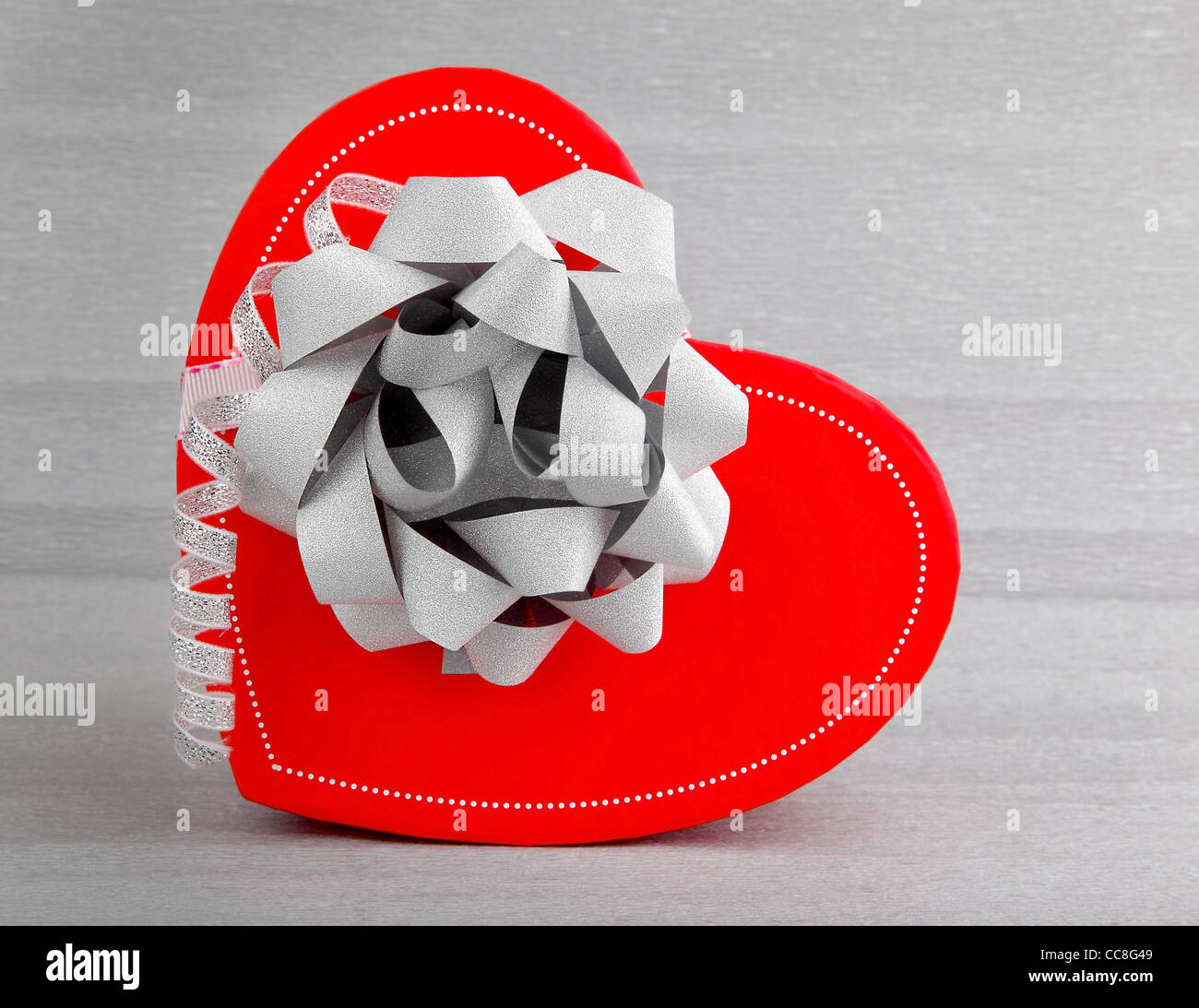 Rotes Herz romantische Geschenk-Box isoliert auf silbernem Hintergrund, Konzeptbild von Liebe & Feier Stockfoto