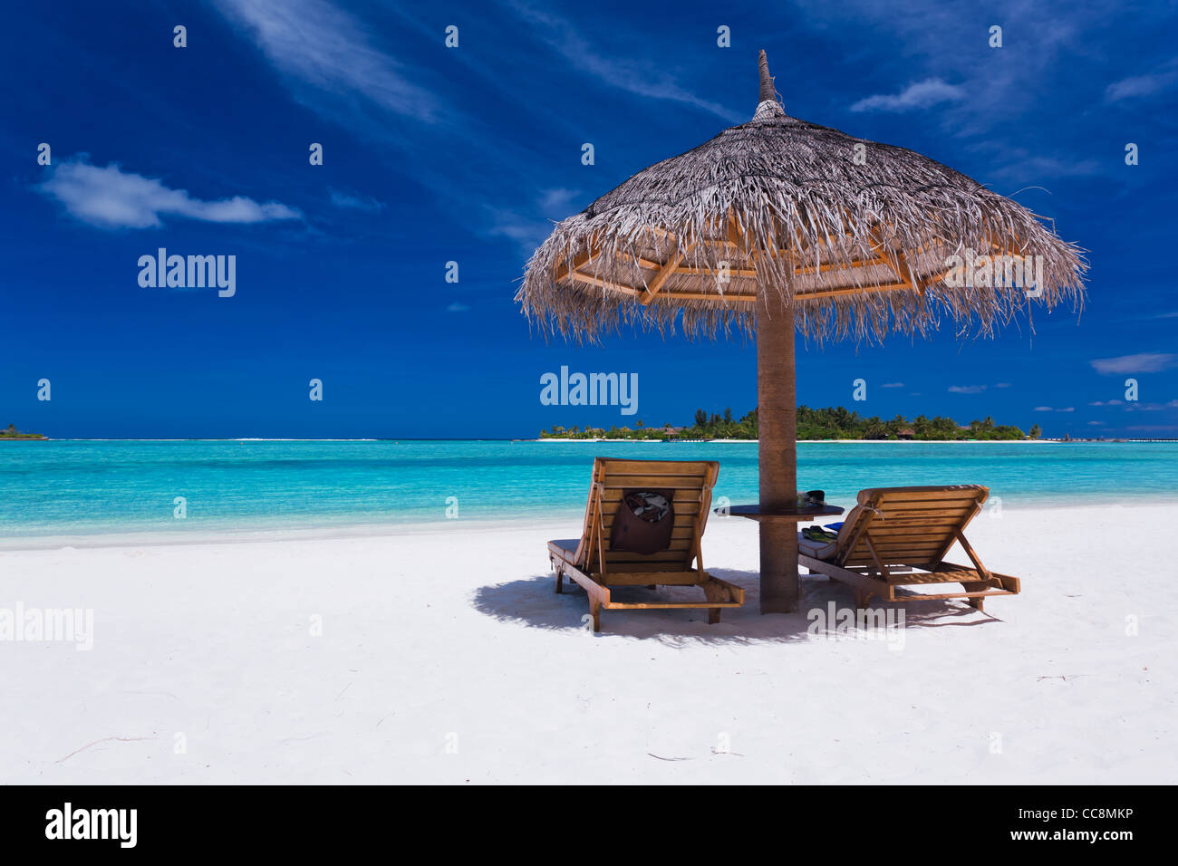 Zwei Stühle und Sonnenschirm am atemberaubenden tropischen Strand Stockfoto
