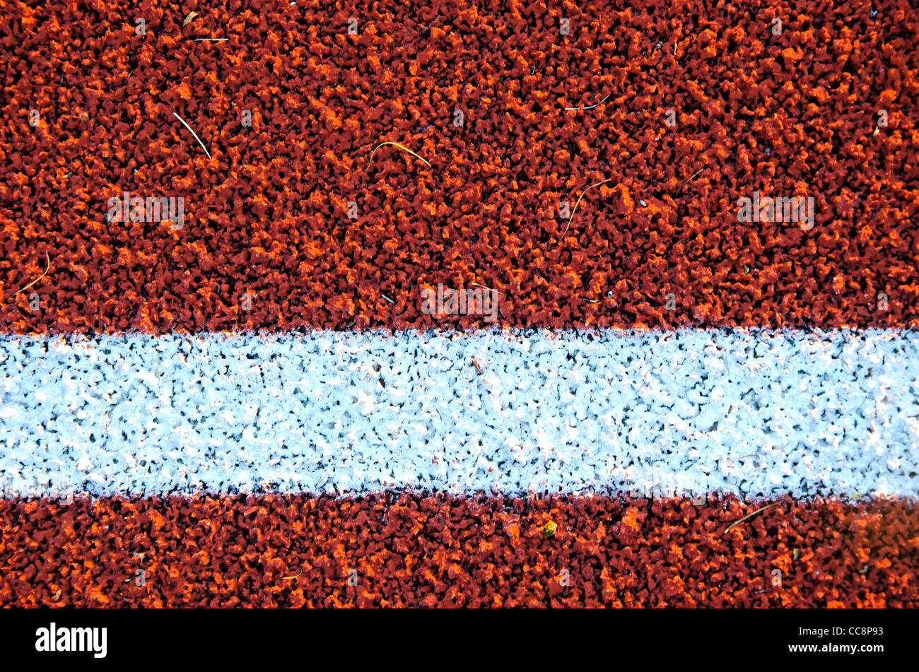 Stadion Laufstrecke Oberfläche Closeup Hintergrund. Interessante Texturen. Stockfoto