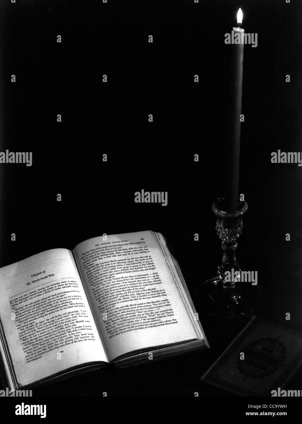 Stillleben mit offenen, brennende Kerze und Buch mit sieben Siegeln Stockfoto
