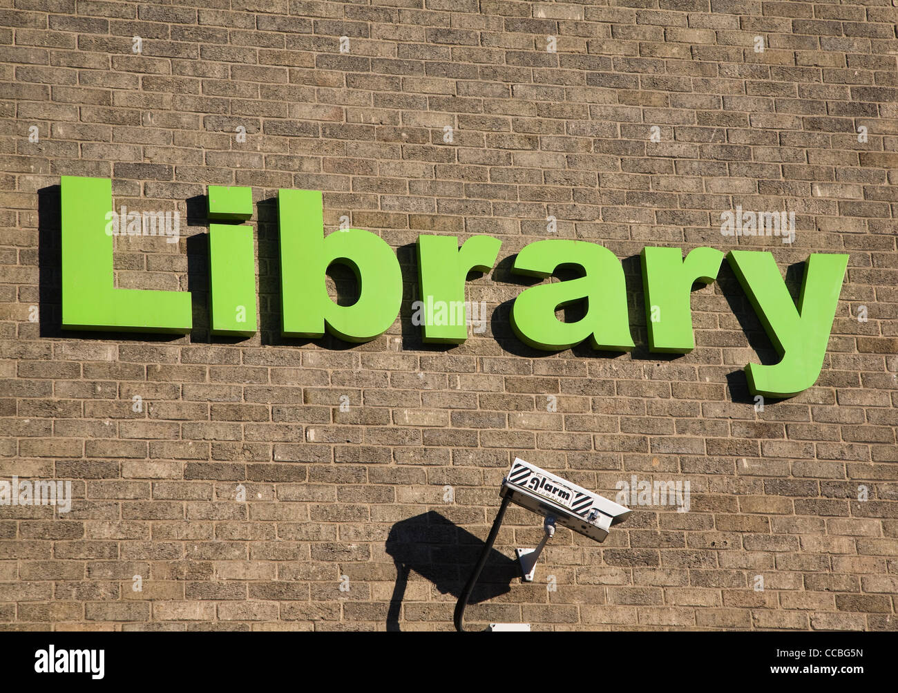 Bibliothek Zeichen grünen Buchstaben Ziegel Wand CCTV-Kamera Stockfoto