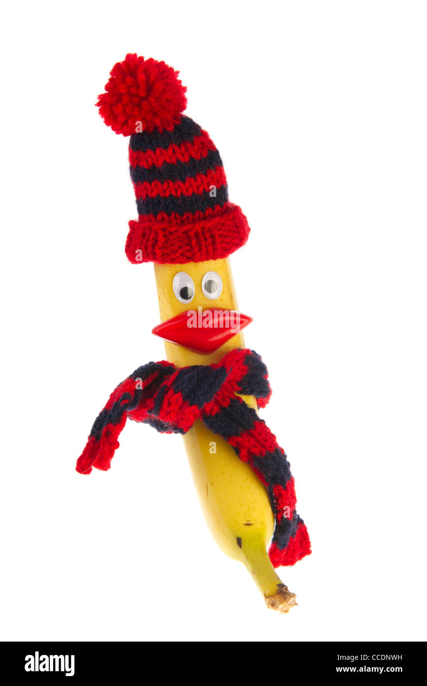 Lustiger Winter Banane Frucht mit gestrickter Mütze und Schal Stockfoto