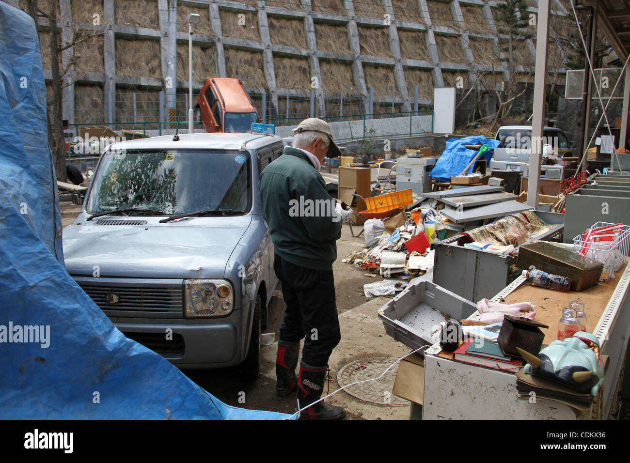 27. März 2011 - Kesennuma, Miyagi, Japan - Stadt versucht, zwei Wochen nach dem verheerenden Tsunami zu formieren.  Kei Saijo, 68, "nehmen Sie es alle, ich bin es wegwerfen."  (Kredit Wesley Cheek/ZUMAPRESS.com ©) Stockfoto
