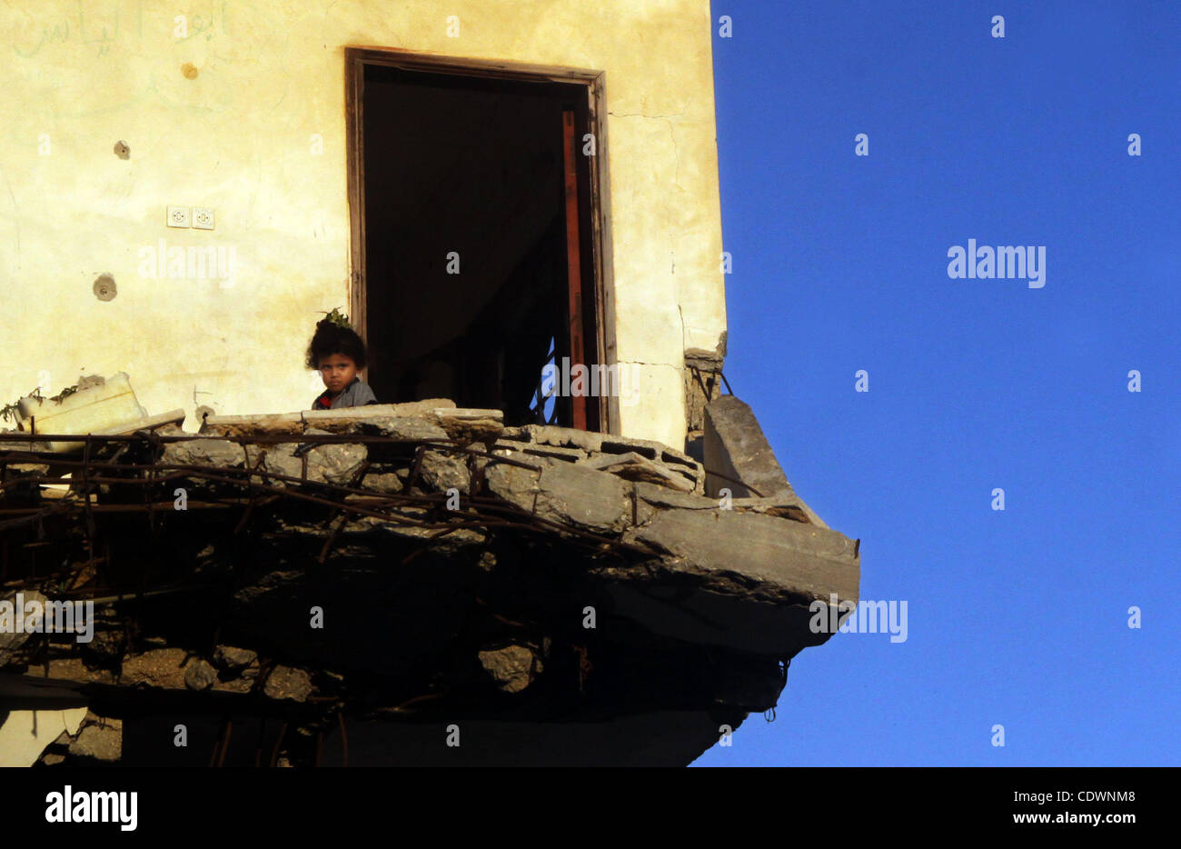 Ein palästinensisches Kind spielt in ihrem familiären zerstörten Haus im Flüchtlingslager Dschabalija im nördlichen Gazastreifen am 23. Juli 2011 Haus zerstört während des israelischen Angriffs auf Gaza Ende 2008, Anfang 2009, und wegen der Blockade von Israel auferlegten Enklave, Bau Materialien Stockfoto