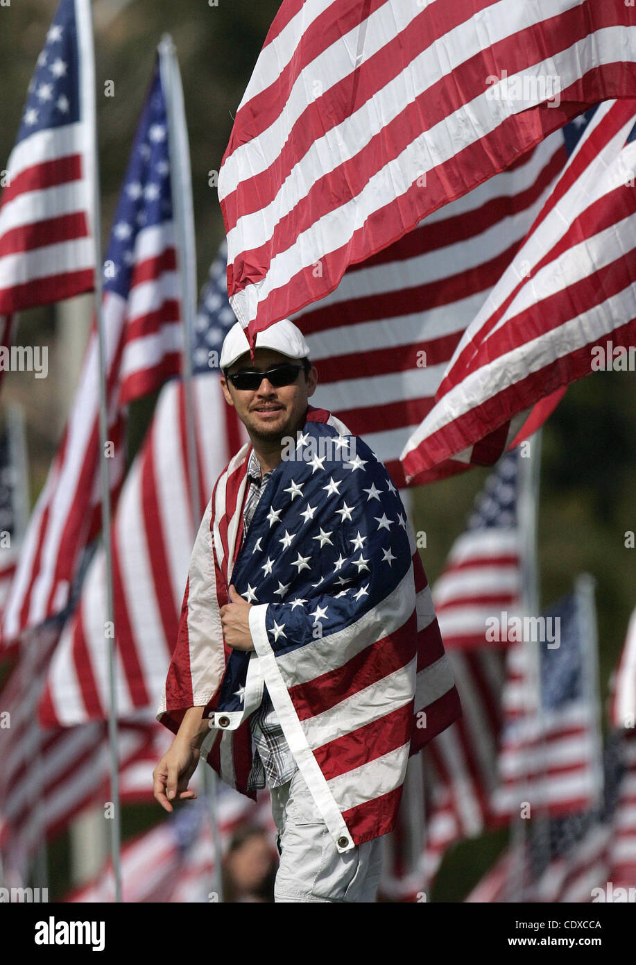 Michael Prince, 38, geht mit einer Fahne unter drei Tausenden von amerikanischen Flaggen an einem Denkmal zu Ehren der Opfer der Terroranschläge 11. September 2001, eingestellt auf Sonntag, 11. September 2011 von Freiwilligen auf dem Campus Rasen der Pepperdine University in Malibu, Kalifornien. (Foto von Ringo Chiu / Zuma Press) Stockfoto