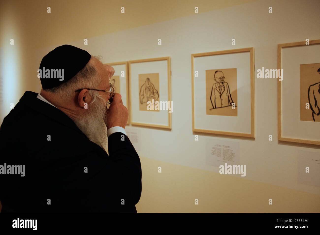 Ein orthodoxer religiöser Jude besucht eine Zeichenausstellung von KZ-Gefangenen in Yad Vashem, dem World Holocaust Remembrance Center, in Jerusalem, Israel, zum Gedenken an die 6 Millionen jüdischen Opfer, die von den Nazis während des Zweiten Weltkriegs getötet wurden Stockfoto