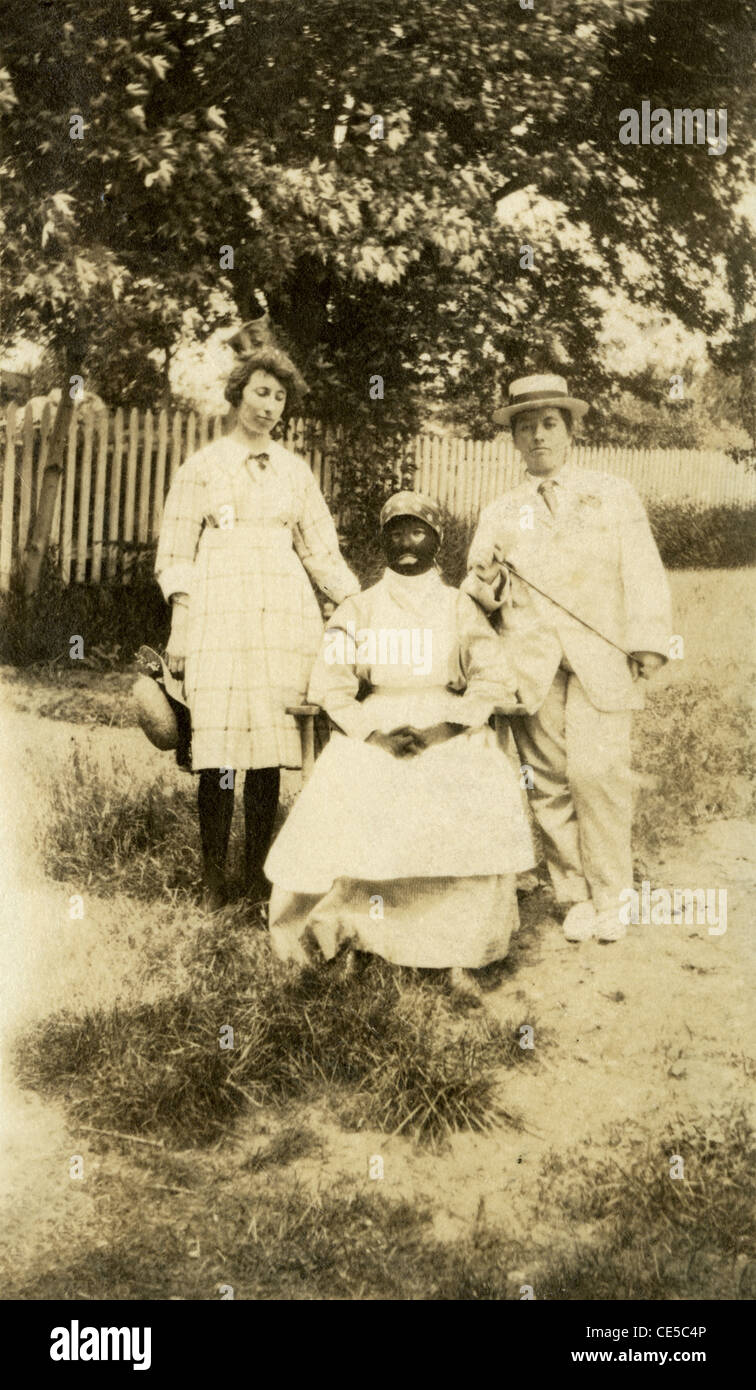 Ca. 1910 s Foto von drei Menschen in Tracht, in Blackface. Stockfoto