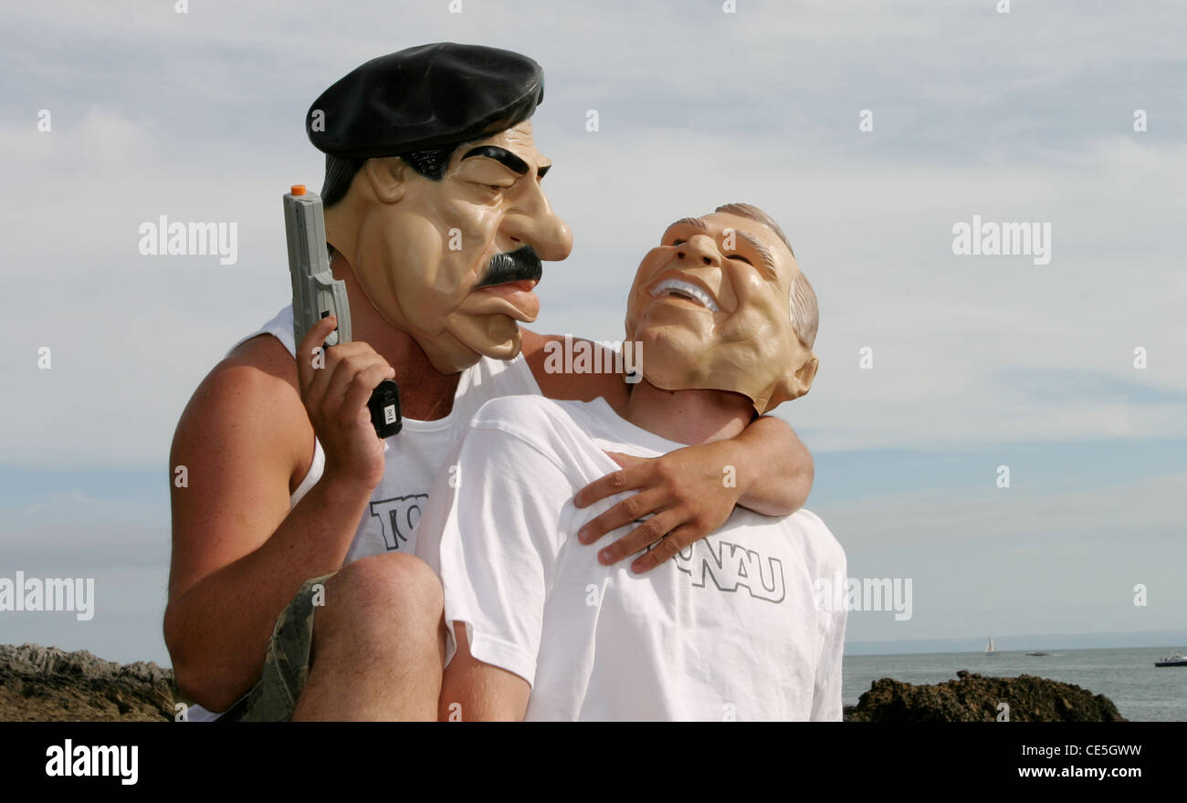 Saddam Hussein hält eine Pistole, George Bush, wie sie einander liebevoll bestaunen. Stockfoto