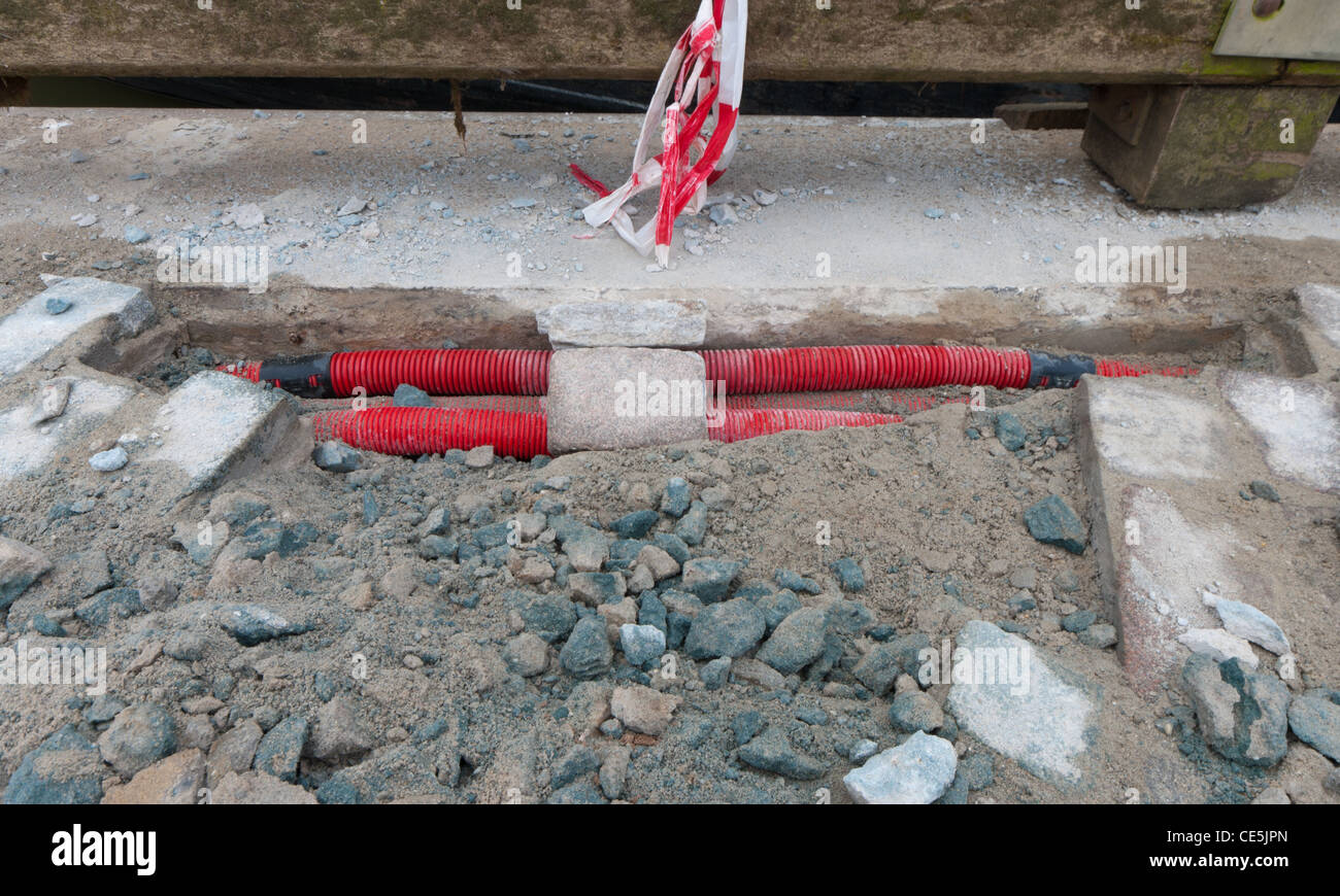 rote Power Kabel vergraben in der Straße Stockfoto