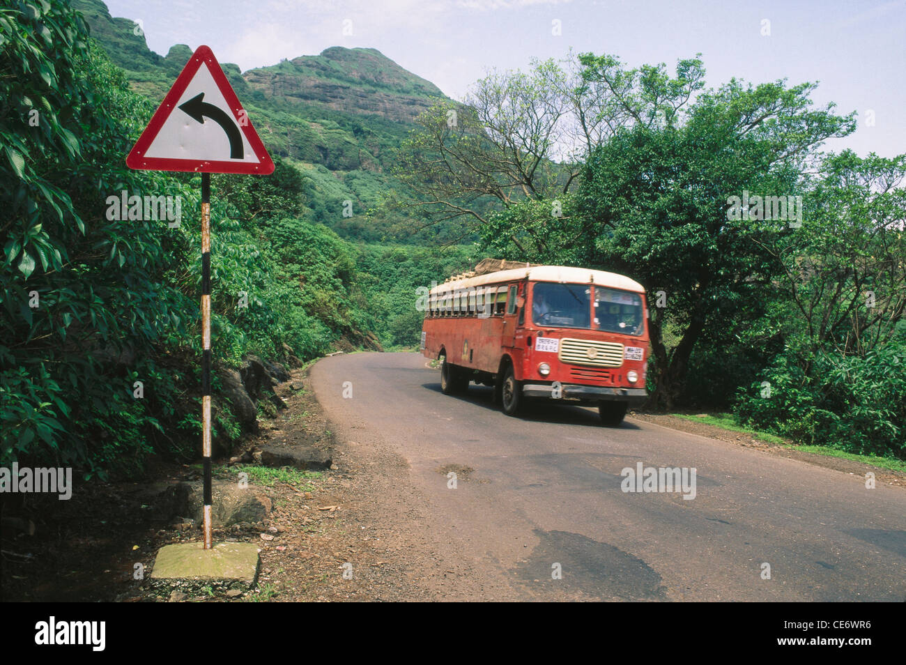 NMK 85377: links abbiegen, Zeichen und State Transport Bus auf Western Ghats Malshej Ghat Straße Maharashtra Indien Stockfoto