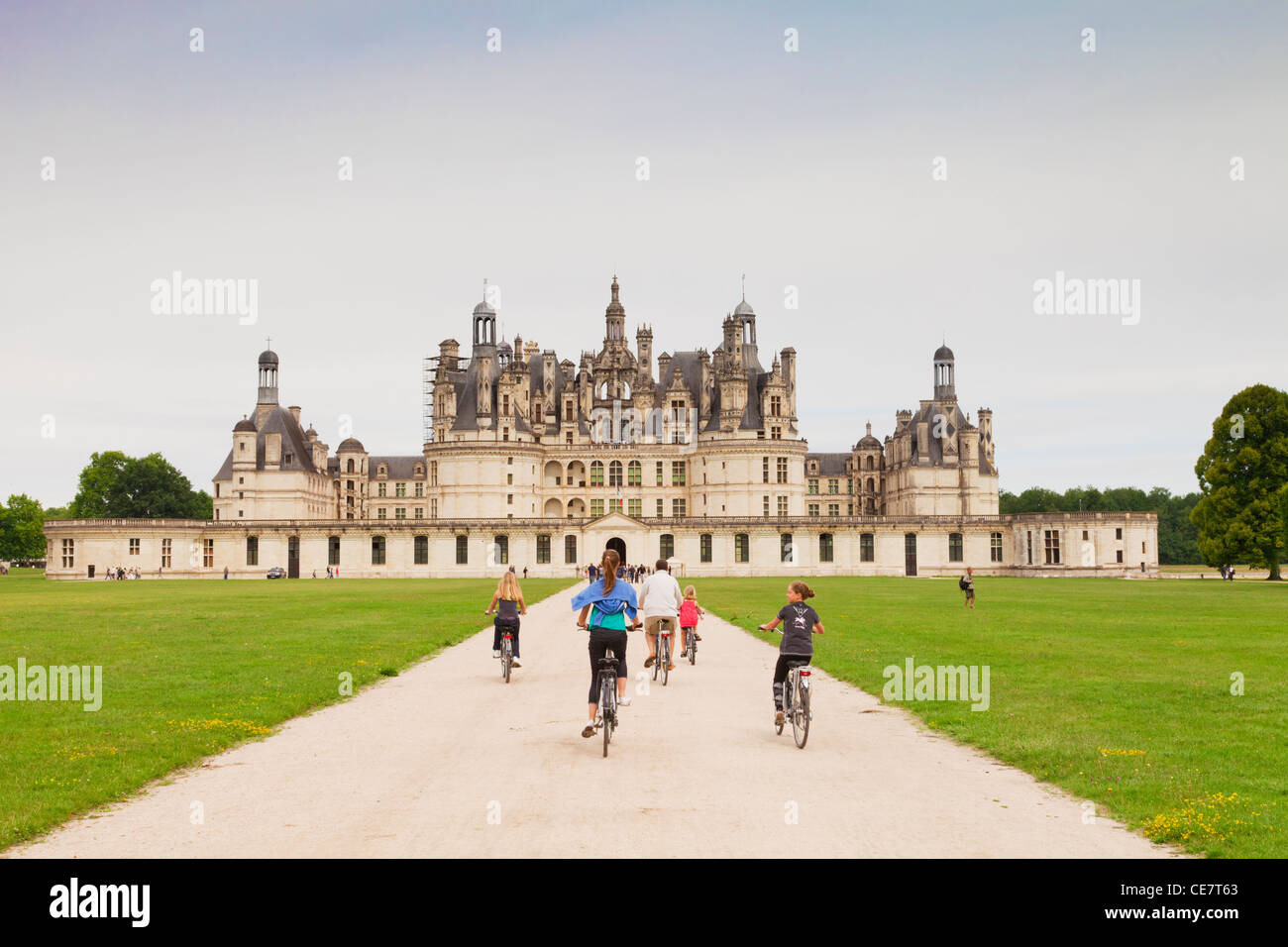 Das Schloss Chambord, Loiretal, Frankreich, und eine Gruppe von Radfahrern nähert. Stockfoto