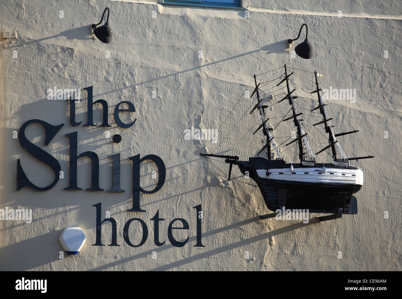 Das Hotel Schiff, Brancaster. Ein Modellschiff hängt an der Außenwand. Stockfoto
