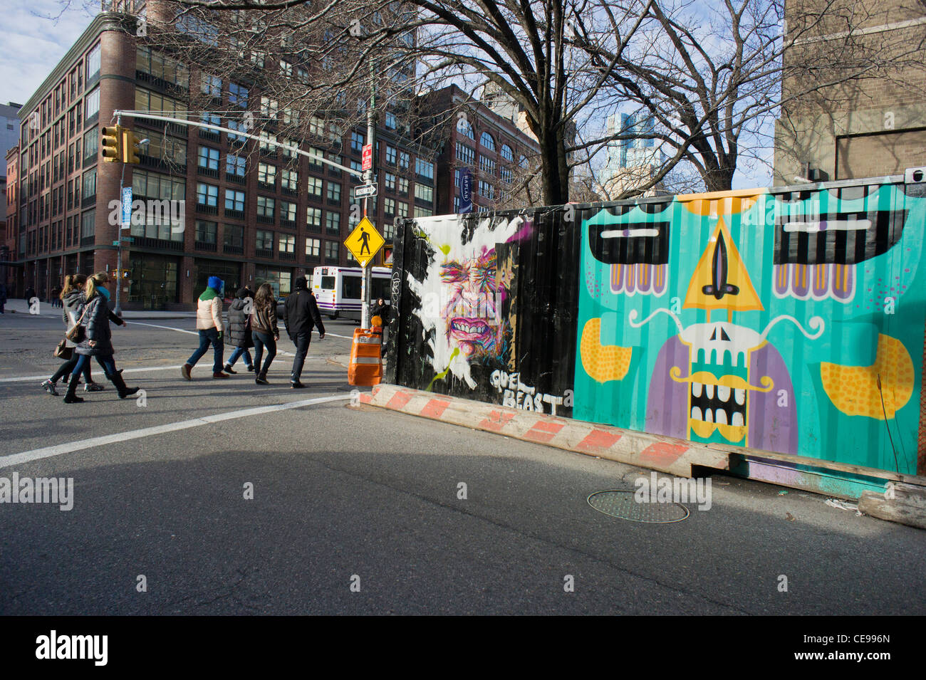 Fußgänger passieren Baucontainern dekoriert mit Graffiti-Stil street-Art in den angesagten Viertel East Village in New York Stockfoto