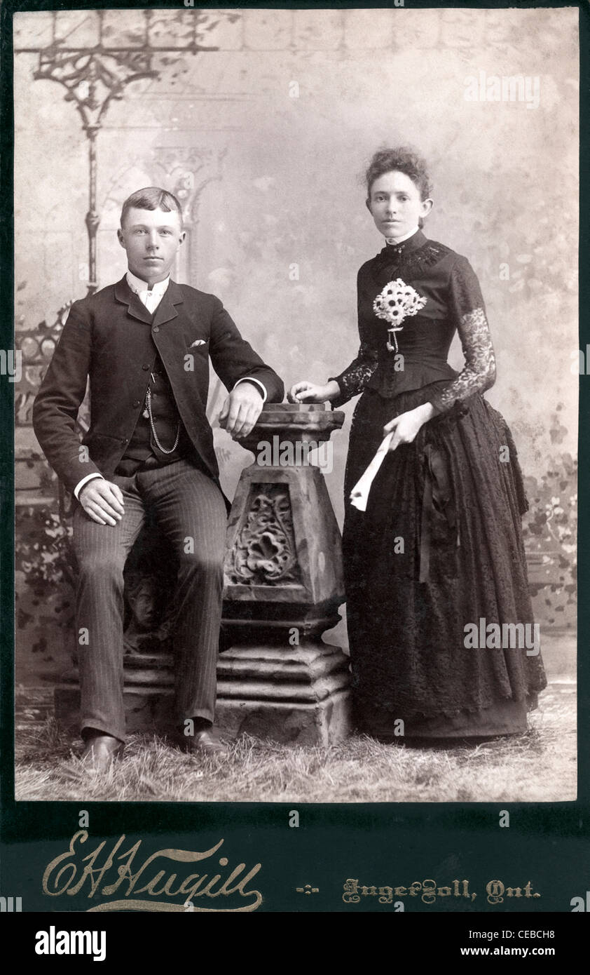 Vintage Foto des Paares posiert im Fotostudio, 1890er Jahre 1910 in festliche Kleidung der Zeit gekleidet. Stockfoto
